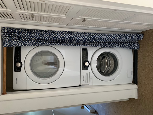 Stacked Samsung washer and dryer in the hall closet