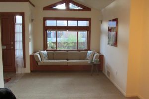 Built-in, sunny sitting area with a bench under a window